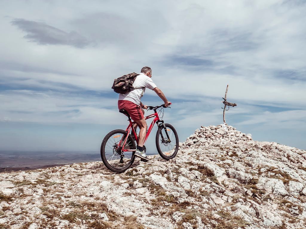 Photo by Mike Man Riding Bicycle on Off-road