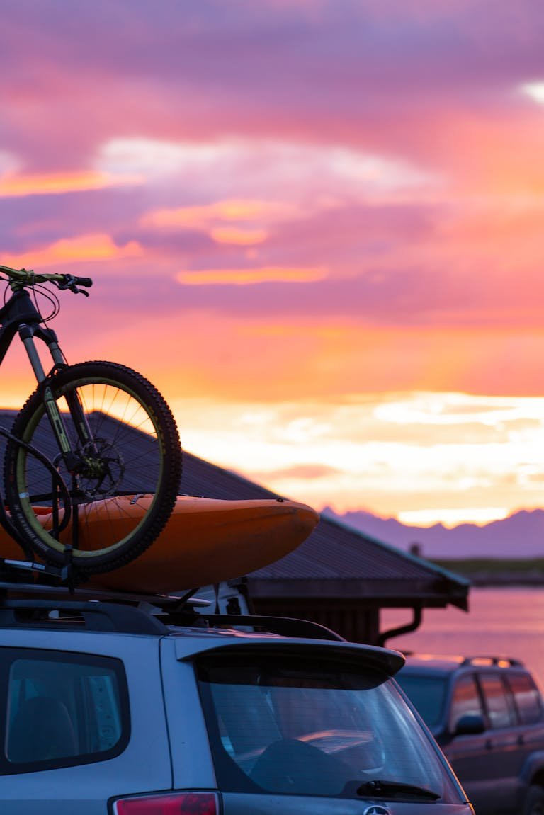 A Mountain Bike on Top of a Sports Utility Vehicle