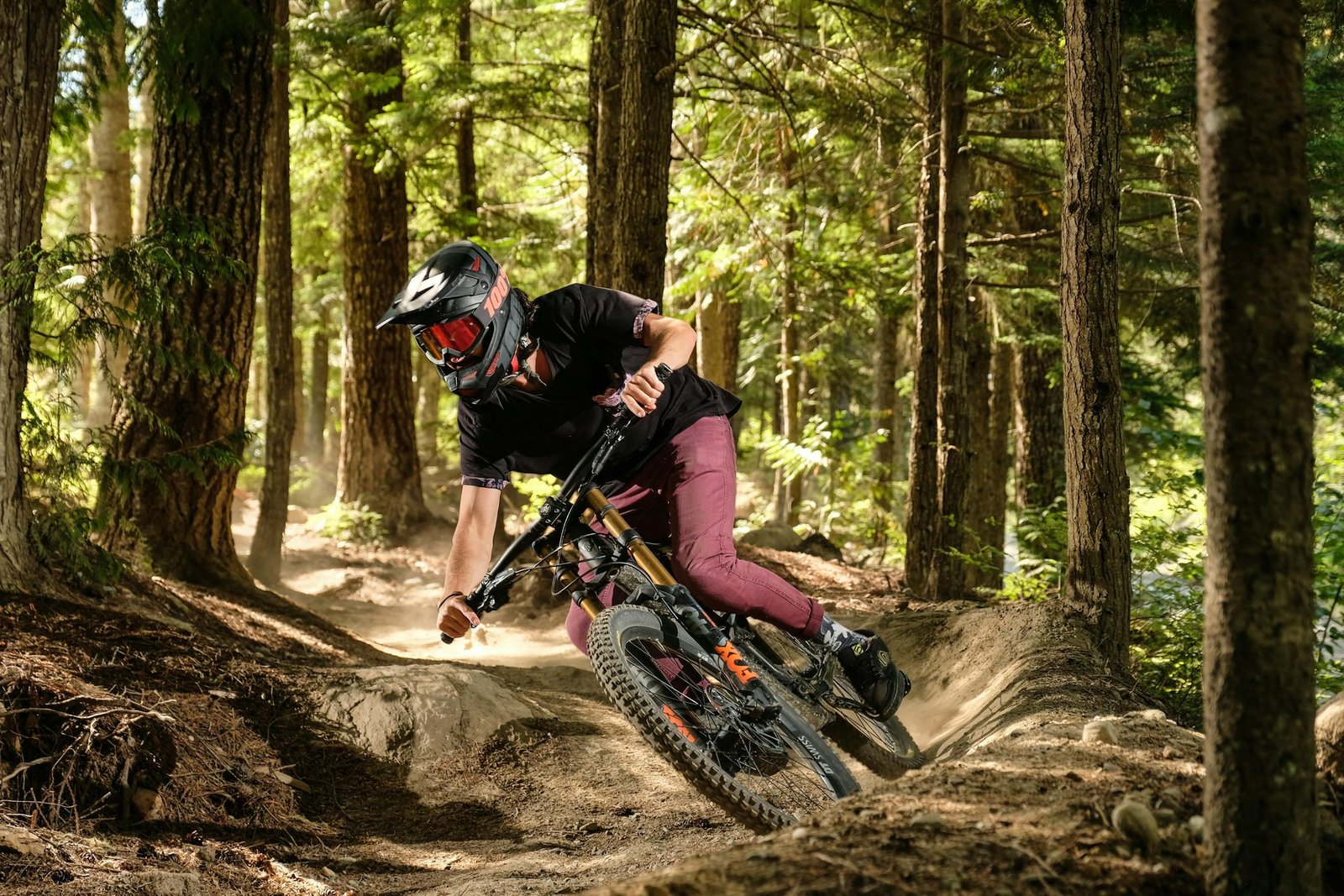 Experience the thrill of mountain biking through a lush forest with speed and precision.