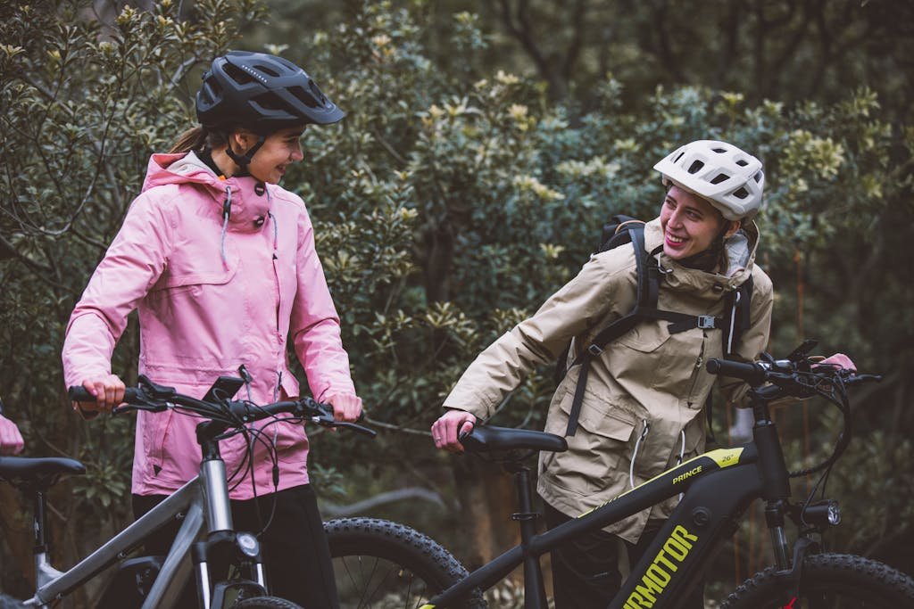 Photo by Motor TruckRun Smiling Mother with Daughter on Bicycles in Forest